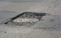 Repair asphalt road pavement hole and laying new asphalt patching method outdoors Royalty Free Stock Photo