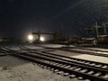 Repair base at winter night. Snowing.