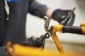 Repair of a bicycle: person disassembling an orange bike at his repair shop