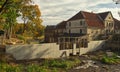 Repair of the bridge and dam at the Aleksupite river waterfall and the former mill, Kuldiga, Latvia Royalty Free Stock Photo