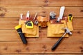 Different work tools in belt on wooden boards