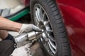 Repair or changing tire car vehicle mechanic screwing car wheel at repair service station Royalty Free Stock Photo