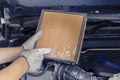 Repair and check car air conditioning system Technician holds car air filter to check cleanliness Clogging dirty or replacing the