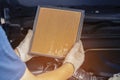 Repair and check car air conditioning system Technician holds car air filter to check cleanliness Clogging dirty or replacing the