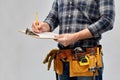 Builder with clipboard, pencil and working tools Royalty Free Stock Photo
