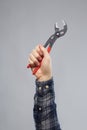 Close up of builder`s hand holding wrench Royalty Free Stock Photo
