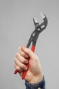 Close up of builder`s hand holding wrench Royalty Free Stock Photo