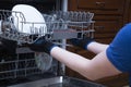 Repair of dishwashers. The master has come home and is repairing the dishwasher Royalty Free Stock Photo