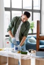 man stirring can with grey color paint at home Royalty Free Stock Photo