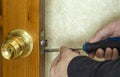 Repair of the door lock. A man repairs a lock Royalty Free Stock Photo