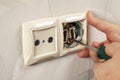 Repair an electrical outlet in the wall of a house