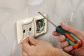 Repair an electrical outlet in the wall of a house Royalty Free Stock Photo