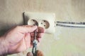 Repair of electrical outlets in the wall of the house.Old broken light switch with power connection in old broken factory. Royalty Free Stock Photo