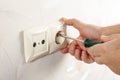 Repair of electrical outlets. Wire drawing with a screwdriver Royalty Free Stock Photo