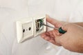 Repair of electrical outlets. Wire drawing with a screwdriver Royalty Free Stock Photo