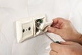 Repair of electrical outlets. Wire drawing with a screwdriver Royalty Free Stock Photo