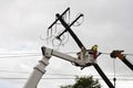 Repair of electricity pole on a cloudy day