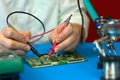 Repair of electronic devices. Measurements of electrical parameters by a multimeter. Royalty Free Stock Photo