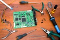 Repair of electronic system board with microcircuits and electronic components. Necessary tools. Royalty Free Stock Photo