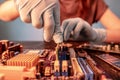 A repair engineer holds a RAM chip with his hands, inserts the RAM into the socket of the computer`s motherboard Royalty Free Stock Photo