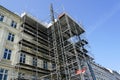 Restoration of the facade of a historic house using scaffolding with temporary elevator Royalty Free Stock Photo