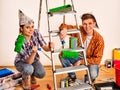 Repair family by happy couple building home using ladder. Royalty Free Stock Photo