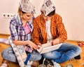 Repair family by happy couple building home using white laptop. Royalty Free Stock Photo