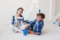 Repair, family and renovation concept - young couple is going to painting the walls, choosing the color Royalty Free Stock Photo