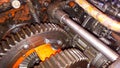 Repair of the gearbox in an old tractor. repairing a tractor used in agriculture. Gears of the rotating shaft of the vehicle.