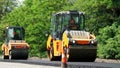 repair of a highway, Road construction works. roller compactor machine and asphalt finisher laying a new fresh asphalt Royalty Free Stock Photo