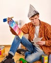 Repair home man holding paint roller for wallpaper. Royalty Free Stock Photo