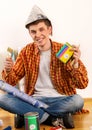 Repair home man holding paint roller for wallpaper. Royalty Free Stock Photo