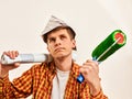 Repair home man holding paint roller for wallpaper. Royalty Free Stock Photo