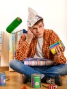 Repair home man holding paint roller for wallpaper. Royalty Free Stock Photo