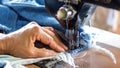 Repair jeans with an old sewing machine. Royalty Free Stock Photo