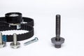 Repair kit: gear belt and bolts isolated on a white background. Car spare parts