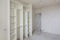 Repair in living room of a new building, built-in wardrobe and closed by a cloth entrance to the room Royalty Free Stock Photo