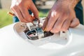 Repair and maintenance of the water heater. The man fixing detail of the boiler. Close up Royalty Free Stock Photo