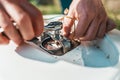 Repair and maintenance of the water heater. The man spins a detail of the wrench. Hands close up Royalty Free Stock Photo