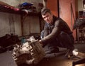 Repair man fixing car in repair station