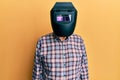 Repair man wearing professional welding mask over head covering face for protection Royalty Free Stock Photo