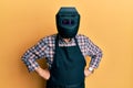 Repair man wearing professional welding mask over head covering face for protection Royalty Free Stock Photo