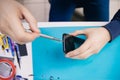 Repair modern mobile phone, master disassembles case to replace broken screen Royalty Free Stock Photo