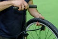 repair mountain bike in the workshop. pump the bike wheel. close-up mechanic