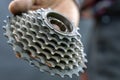 Repair of mountain and road bikes. Mechanic's hands and a cassette close-up on a black background. Royalty Free Stock Photo