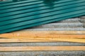 Metal profiled sheet with and wooden battens lies on old roof made of asbestos-cement sheets