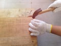 Repair pallet using hammer and nail.