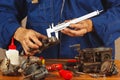 Repair of parts of automotive engine in workshop