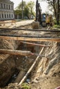 Repair of a pipe, an excavator on the road Royalty Free Stock Photo