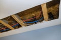 Repair plumbing line with a leaking pipe in a ceiling